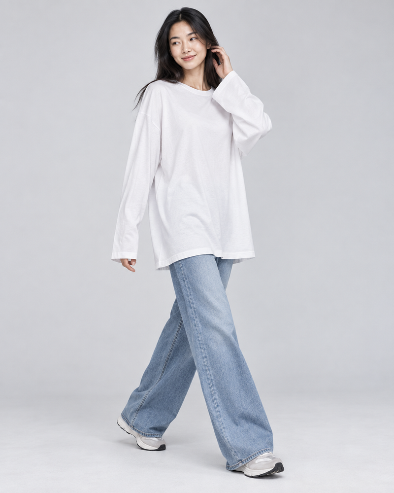 White DAILY long-sleeve T-shirt styled with light blue wide-leg jeans